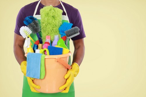 Carpet cleaning technician with protective equipment in a Brixton home